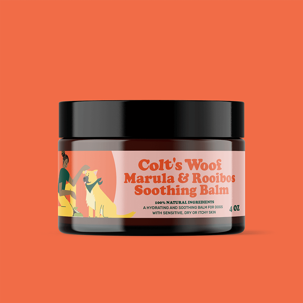 Jar of 'Colt's Woof Marula & Rooibos Soothing Balm' on an orange background